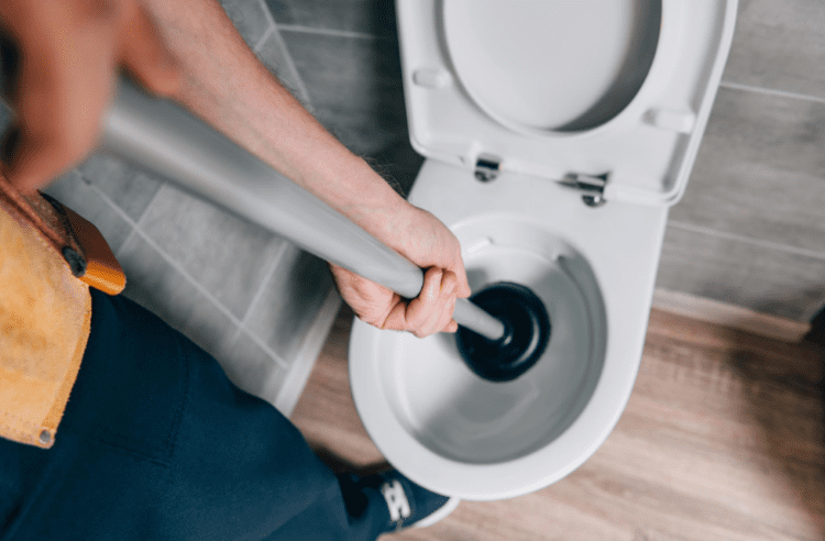 unblocking toilet with a plunger